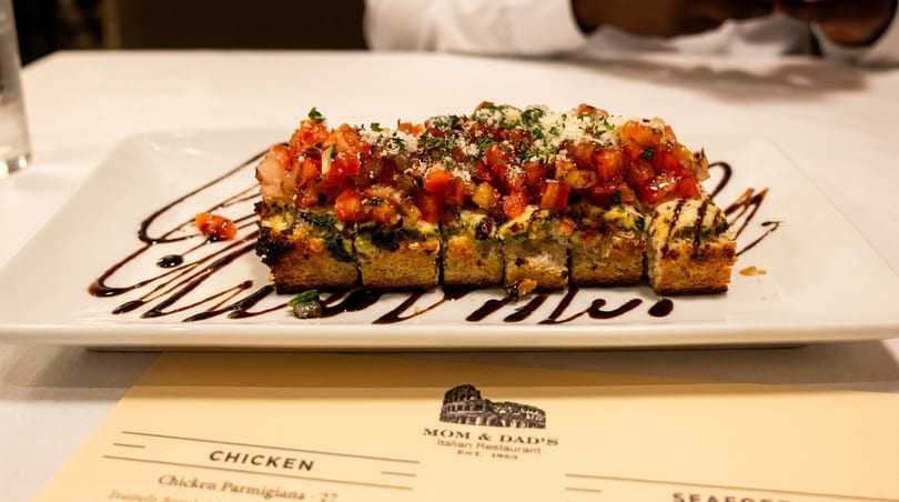 Mom & Dad's Italian Restaurant's bruschetta appetizer, topped with diced tomatoes, cheese, and balsamic glaze.